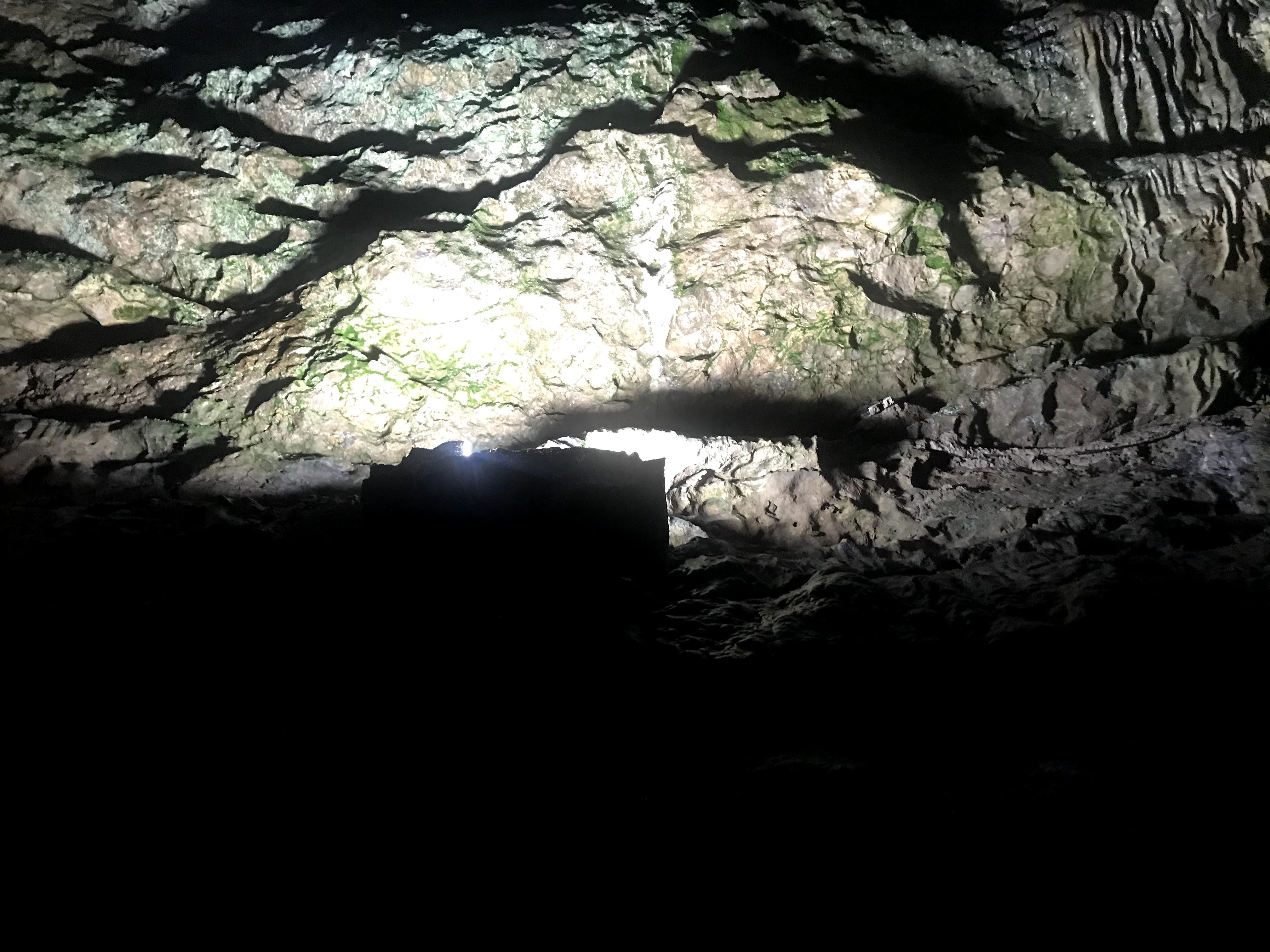 A cave being lit up with a white light.
